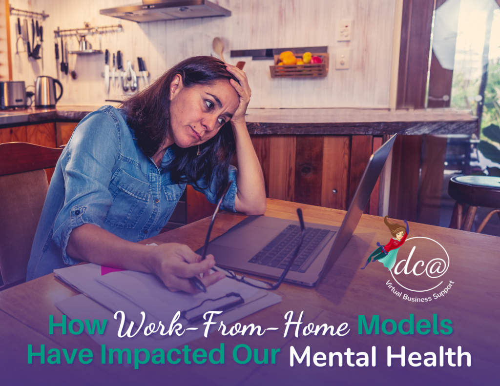 How Work-From-Home Models Have Impacted Our Mental Health. Image of a stressed-looking woman sitting in her kitchen, looking at her laptop as she holds her glasses and an ink pen in one hand and her head in the other. DCA Virtual Business Support.