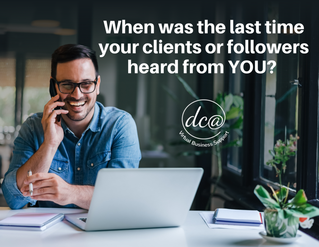 When was the last time your clients or followers heard from YOU? Image of a man smiling while talking on the phone. He's sitting at a desk with an open laptop infront of him. DCA Virtual Business Support. Showing Up